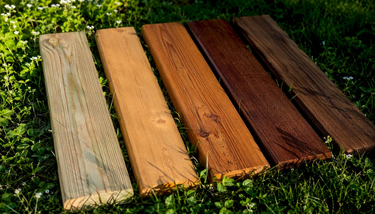 Wood fence boards of different species arranged outdoors