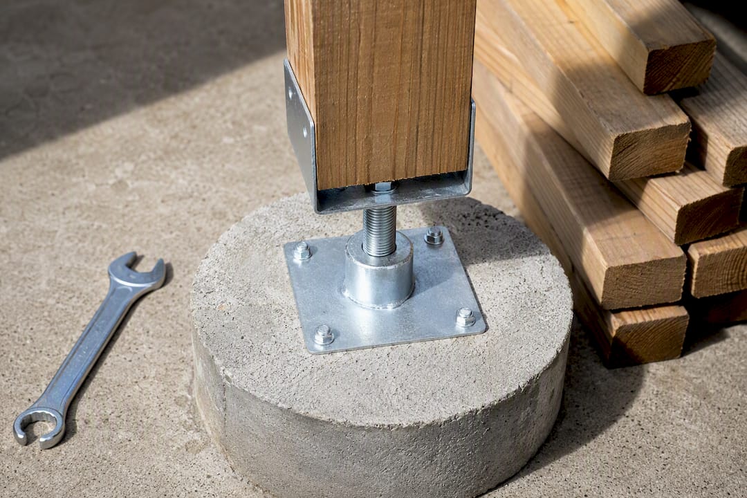 Adjustable galvanized standoff separating post from concrete