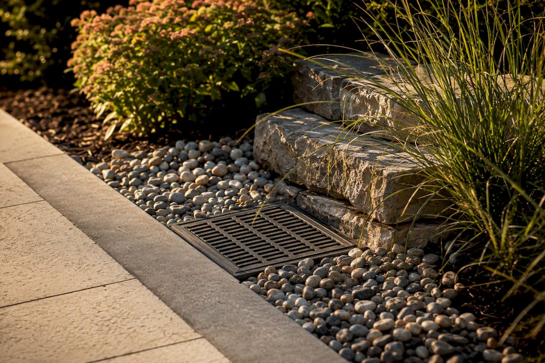 Planted drainage outlet beside retaining wall