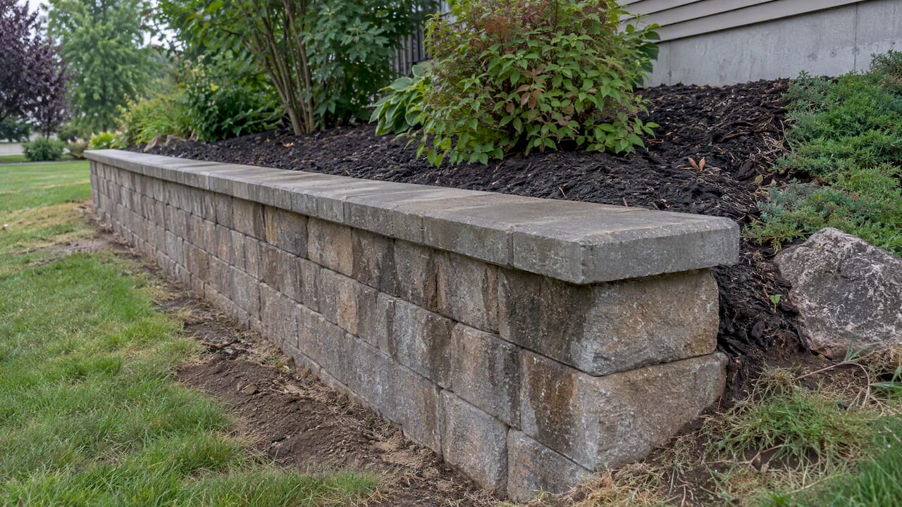 Retaining wall caps with sealed joints